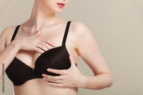 Girl getting comfortable in her bra photo