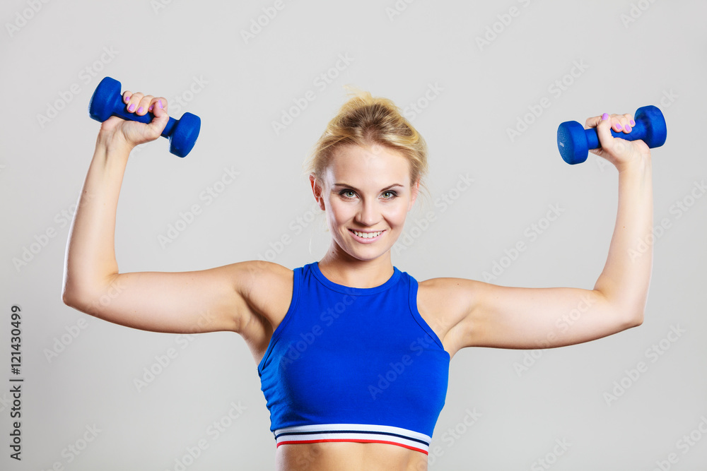 Fit woman lifting dumbbells weights Fit woman lifting dumbbells weights