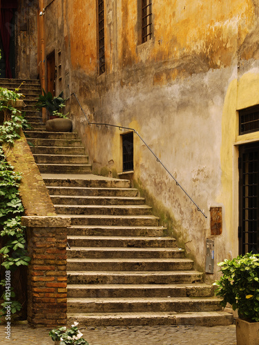 Photography Old and ramshackle stair on the narrow streets of Rome. Italy