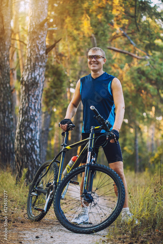 Fototapeta Naklejka Na Ścianę i Meble -  man cyclist rides forest paths