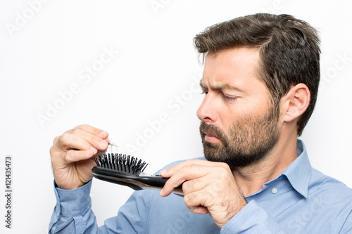 Man watching at hair brush