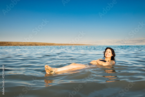 Girl floating on the Dead Sea