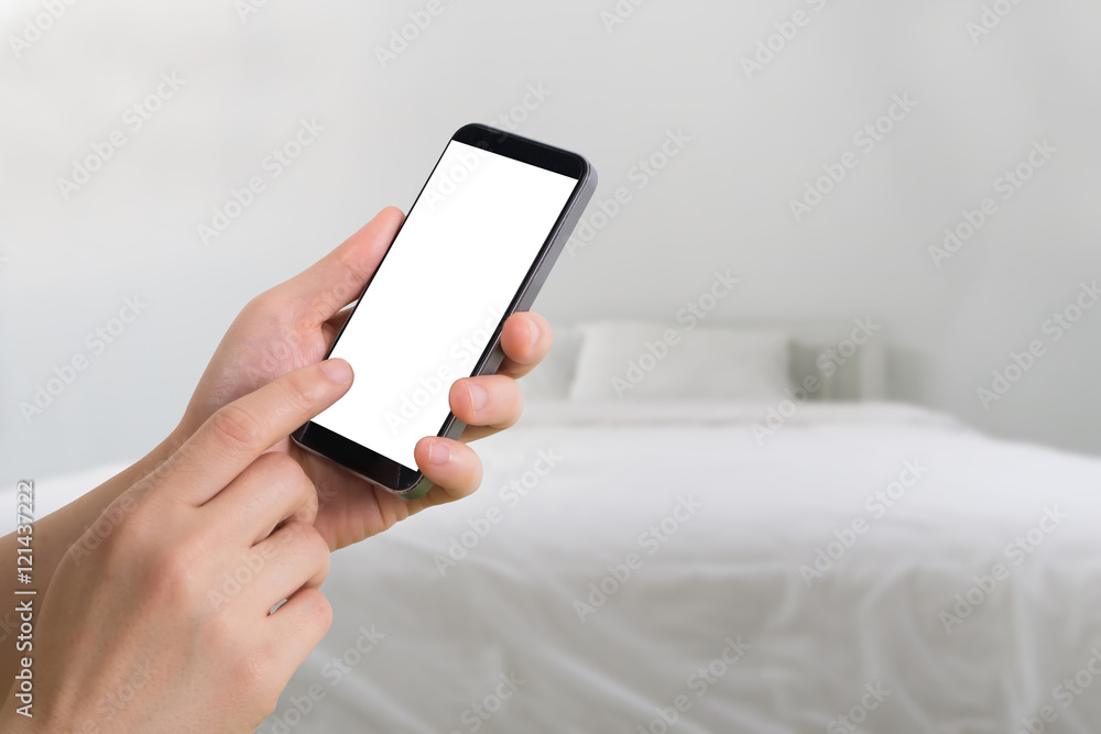 human hand hold and touch smartphone on blurry bedroom background. human hand hold and touch smartphone on blurry bedroom background.