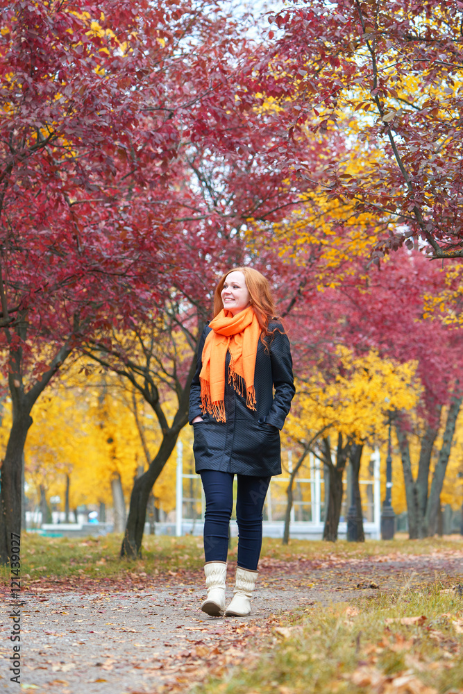 girl walk on footpath in city park, fall season girl walk on footpath in city park, fall season