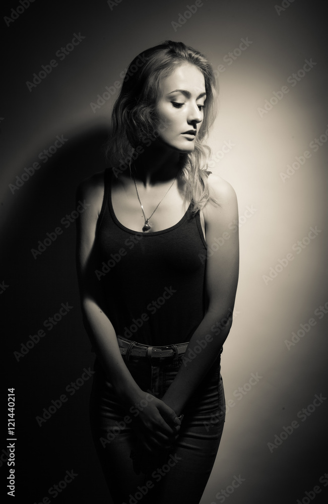 Naklejka premium Beautiful blonde on a black background.