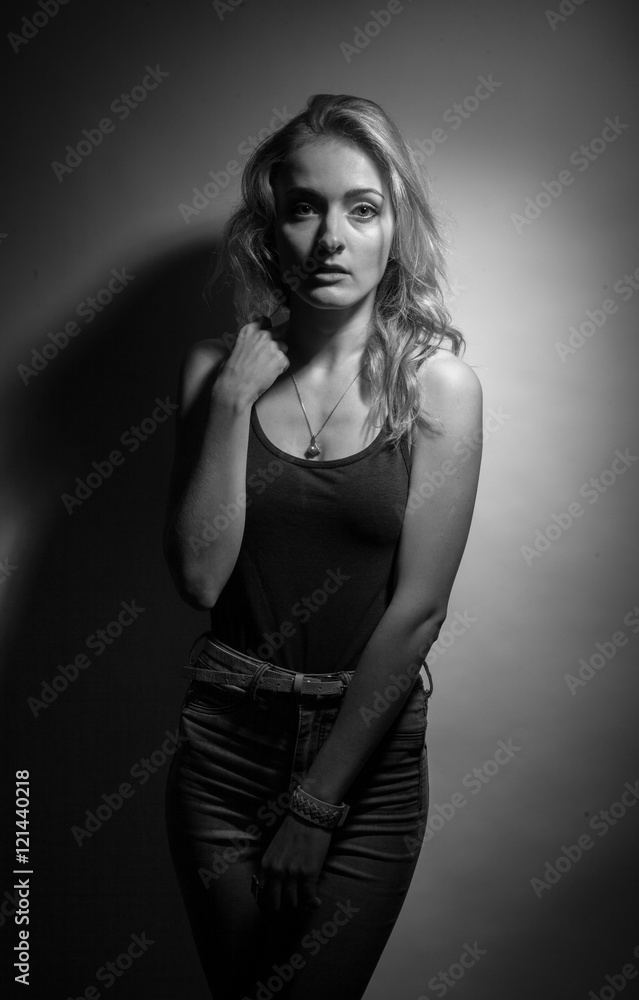 Fototapeta premium Beautiful blonde on a black background.