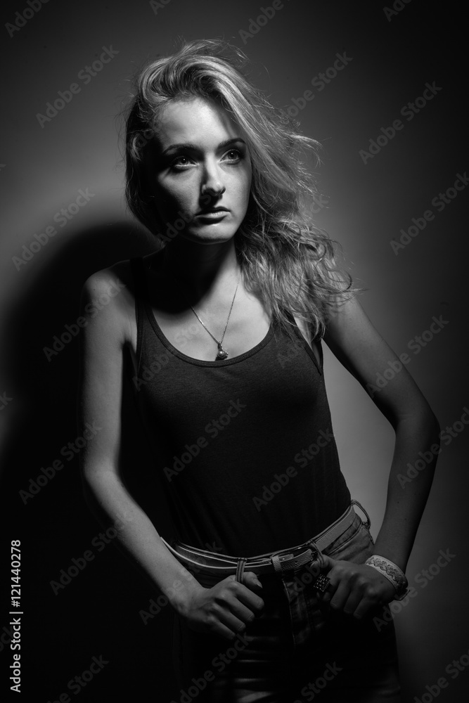 Fototapeta premium Beautiful blonde on a black background.