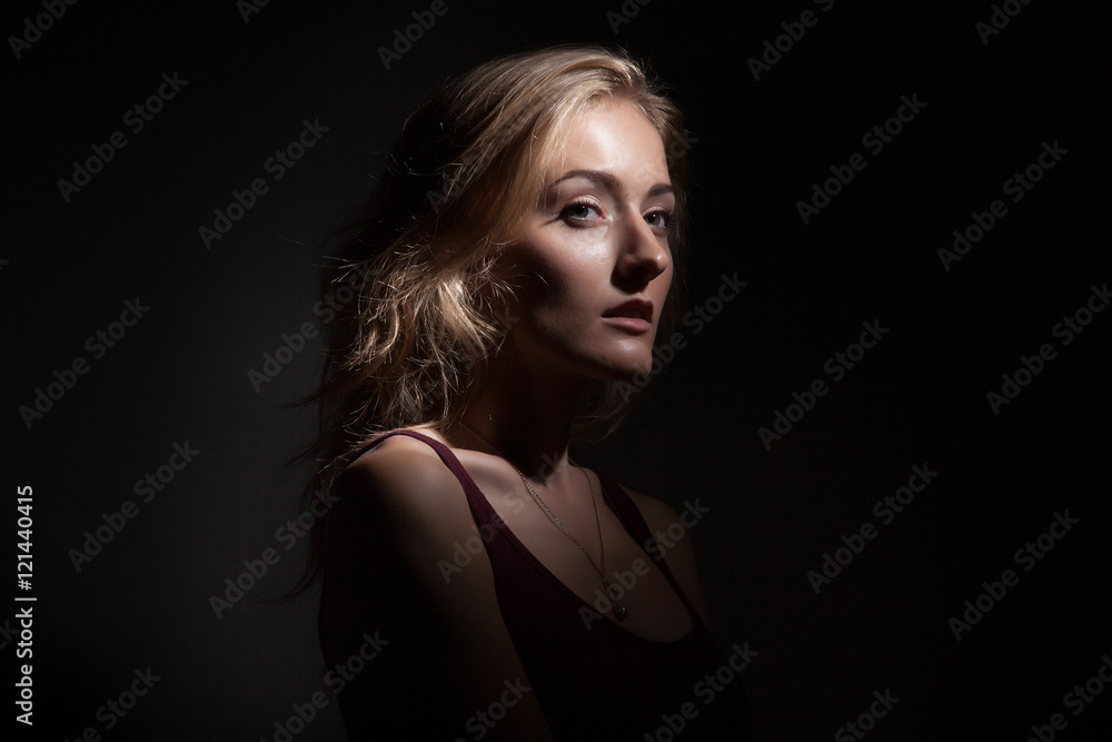 Portrait of a beautiful blonde on a black background Portrait of a beautiful blonde on a black background