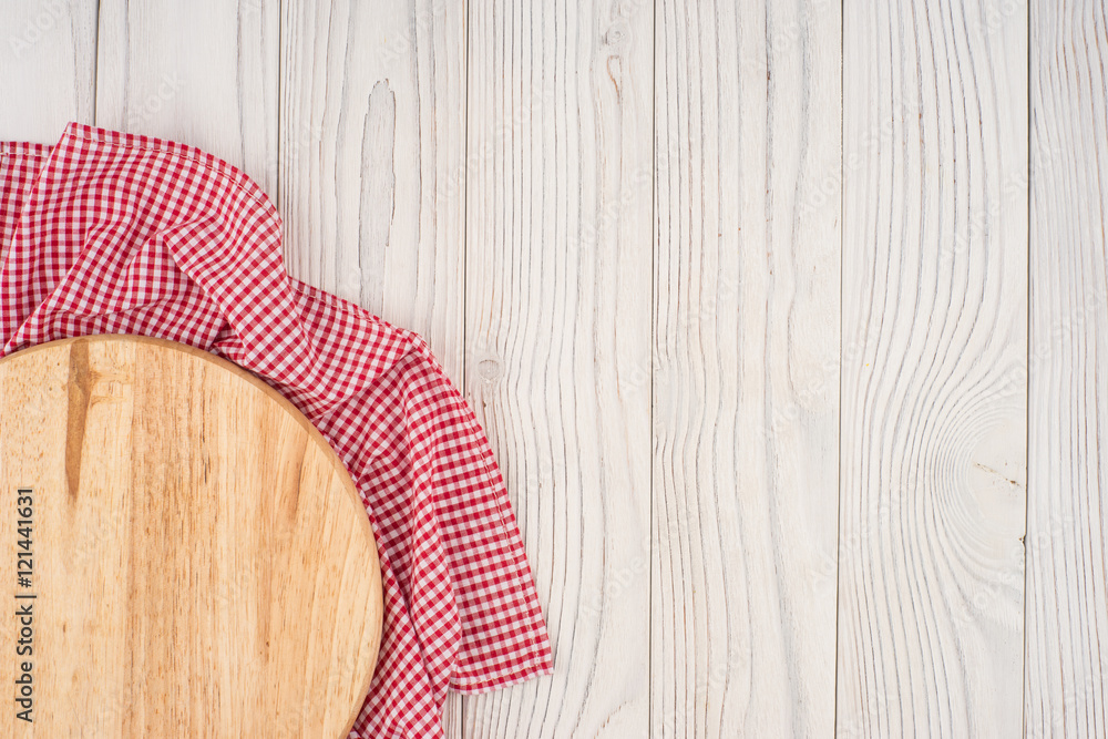 Cutting board on a kitchen napkin on old wooden table. Cutting board on a kitchen napkin on old wooden table.