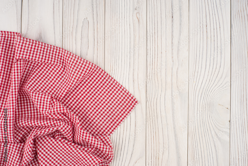Red folded tablecloth over bleached wooden table. Red folded tablecloth over bleached wooden table.