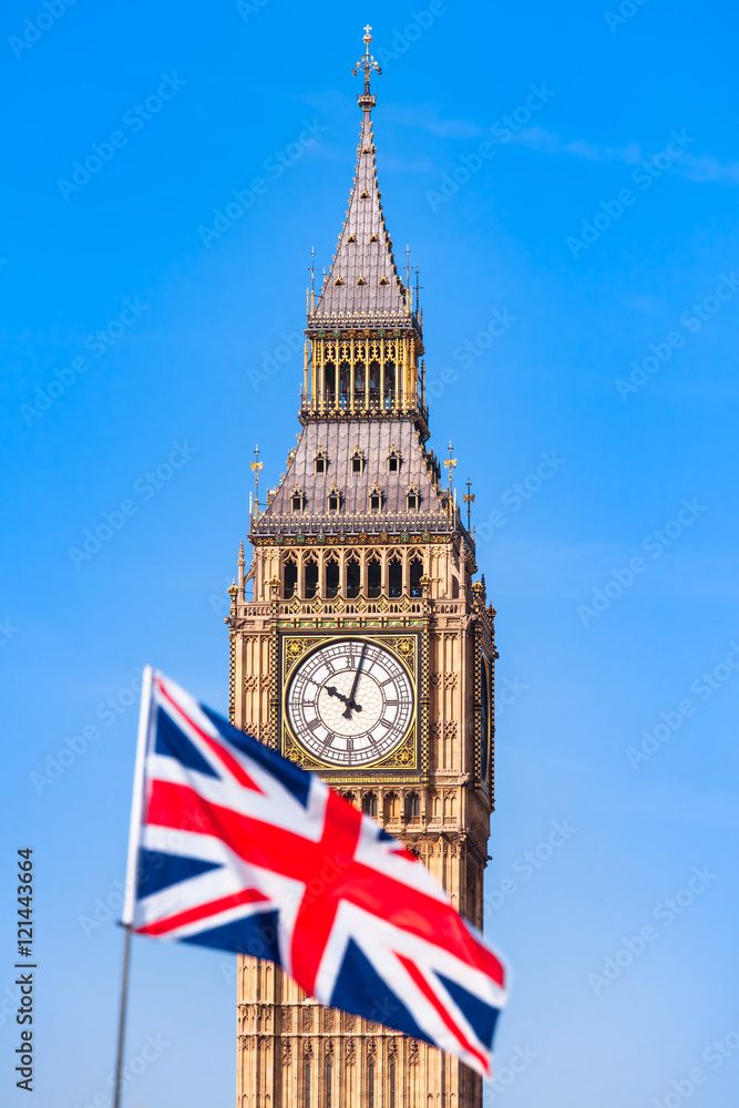 Obraz premium UK Flag and London Sight / Blurry Union Jack flag in front of London Big Ben clock tower and blue sky