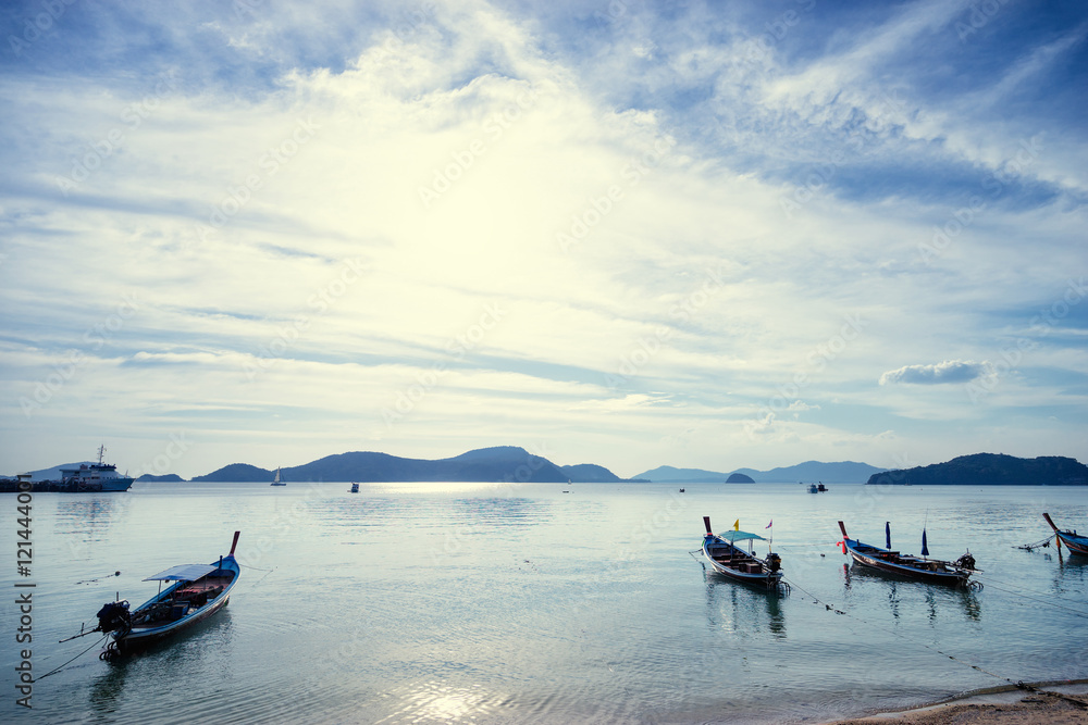 Travel Asia. Beautiful seascape.Traditional Thailand long tail boats with cloudy sky and mountains on horizon. Travel Asia. Beautiful seascape.Traditional Thailand long tail boats with cloudy sky and mountains on horizon.