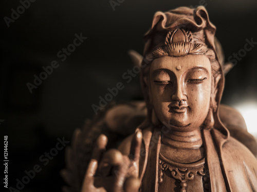 Vintage style of Buddha statue with light dark background and focus face. buddha image used as amulets of Buddhism religion.