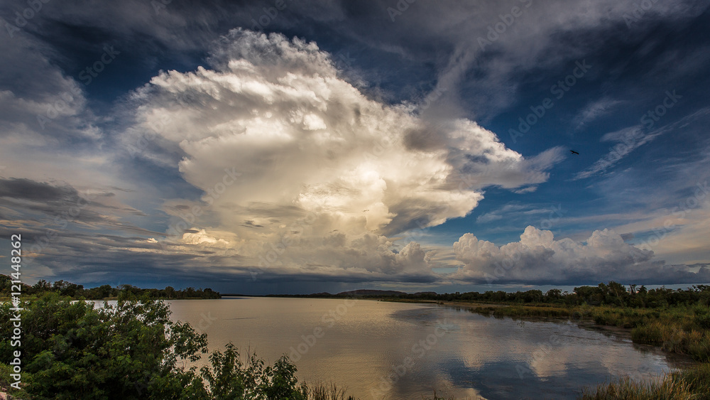 Massive thunderhead in the Kimberley at sunset with Lake Kununurra in foreground