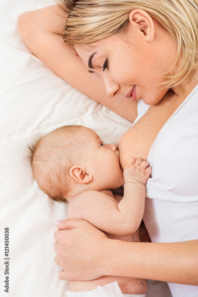 Young mother breastfeeds her baby. Breast-feeding. Young mother breastfeeds her baby. Breast-feeding.