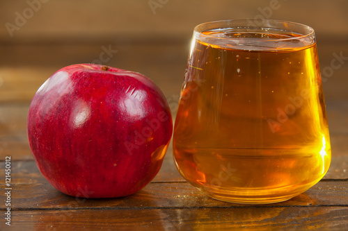 Delicious fresh squeezed apple juice in transparent glass