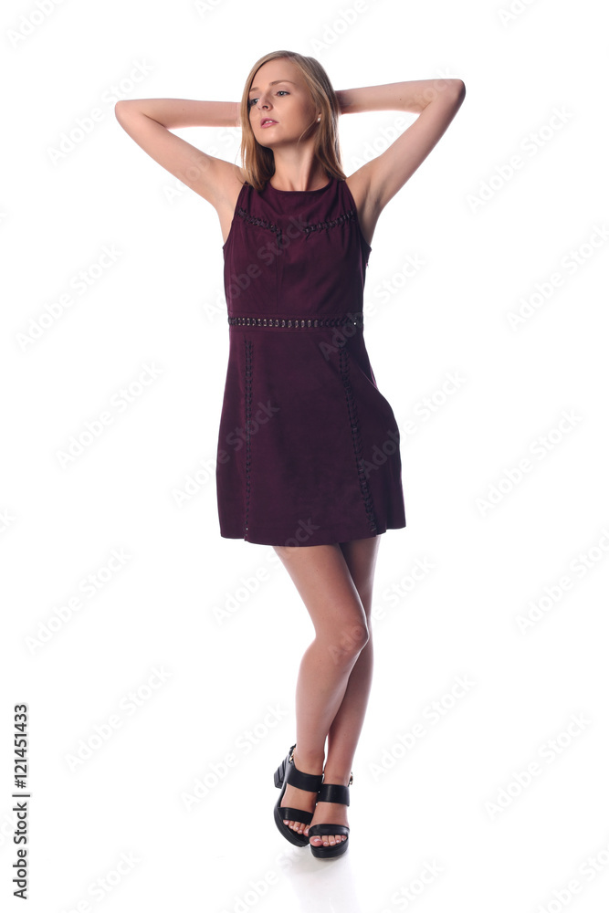 Young pretty long haired blonde woman posing in fashion dress on white background in a studio. Spring summer photo, catalog collection.