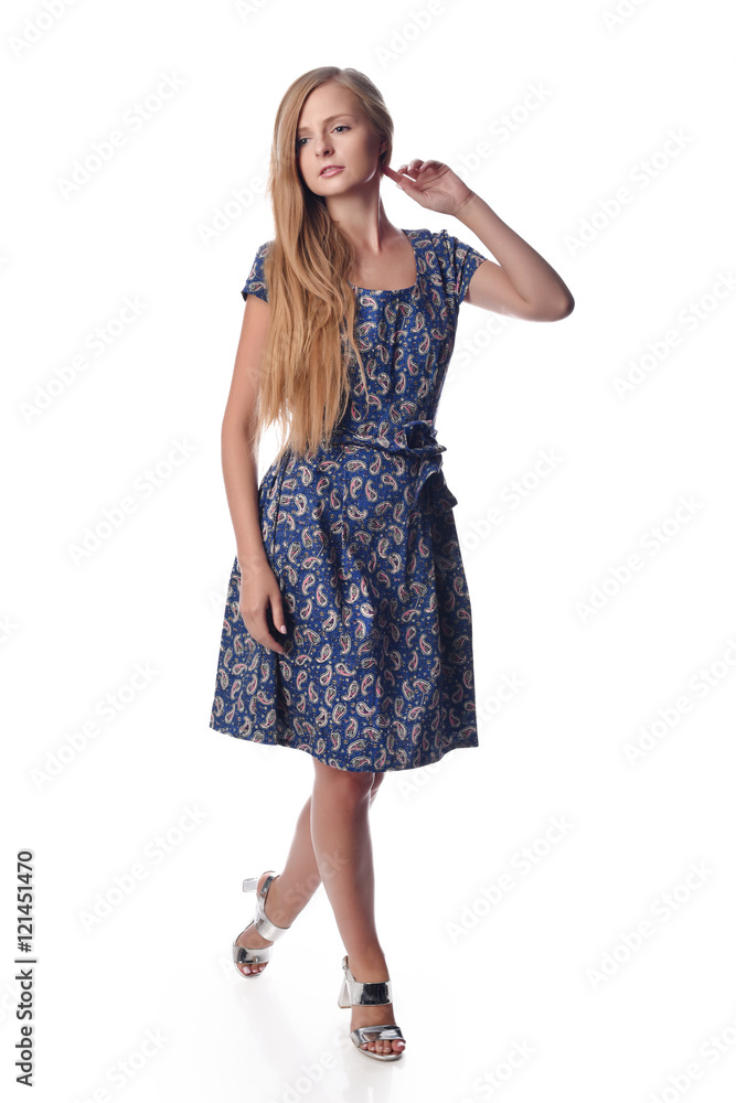 Young pretty long haired blonde woman posing in fashion dress on white background in a studio. Spring summer photo, catalog collection. Young pretty long haired blonde woman posing in fashion dress on white background in a studio. Spring summer photo, catalog collection.