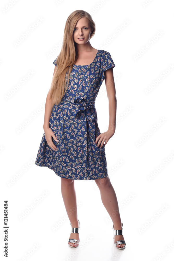 Young pretty long haired blonde woman posing in fashion dress on white background in a studio. Spring summer photo, catalog collection. Young pretty long haired blonde woman posing in fashion dress on white background in a studio. Spring summer photo, catalog collection.