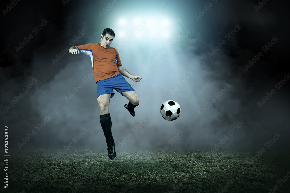 Soccer player with ball in action outdoors