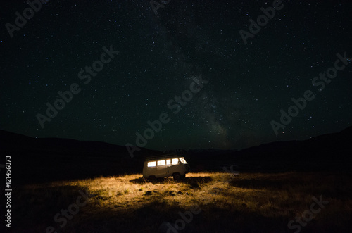 The car with the light from windows and night sky