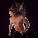 Young man with long hair dragging something behind him. Strong.