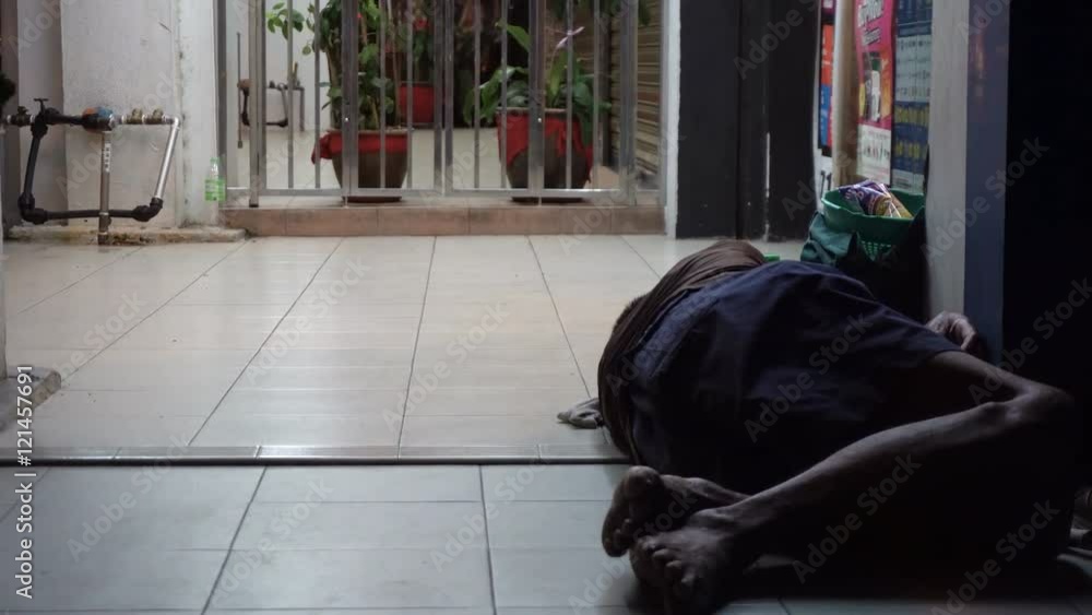 Homeless man sleeping outside on the street Homeless man sleeping outside on the street