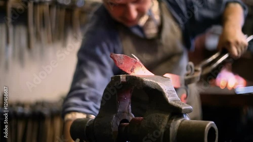 twisting metal on a blacksmith's vise