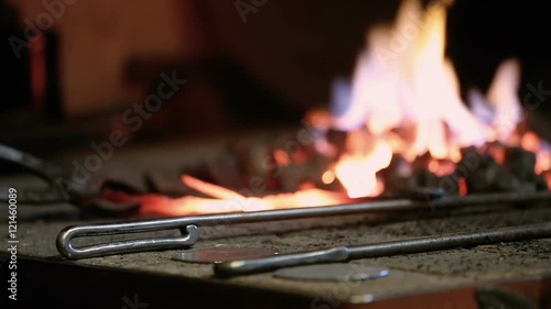 blacksmith heats metal in furnace