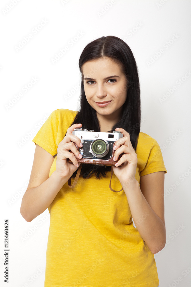Young Woman Holding retro camera against white background Young Woman Holding retro camera against white background