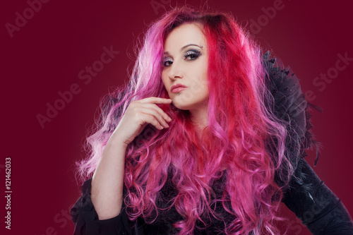 Attractive woman with pink hair in witch image. Halloween style