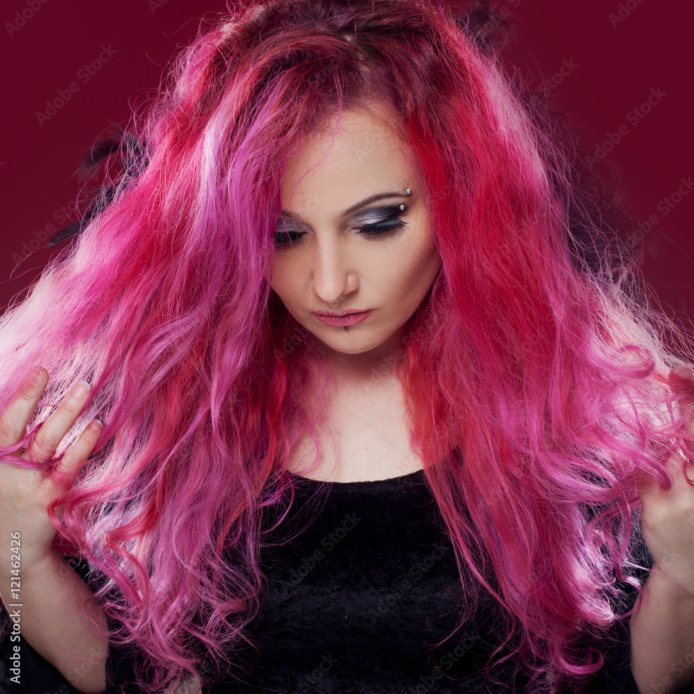Fototapeta premium Attractive woman with pink hair in witch image. Halloween style