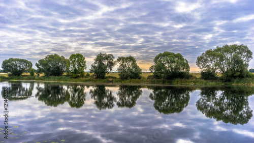 Beautiful panoramic landscape  cloudy sky  trees and water