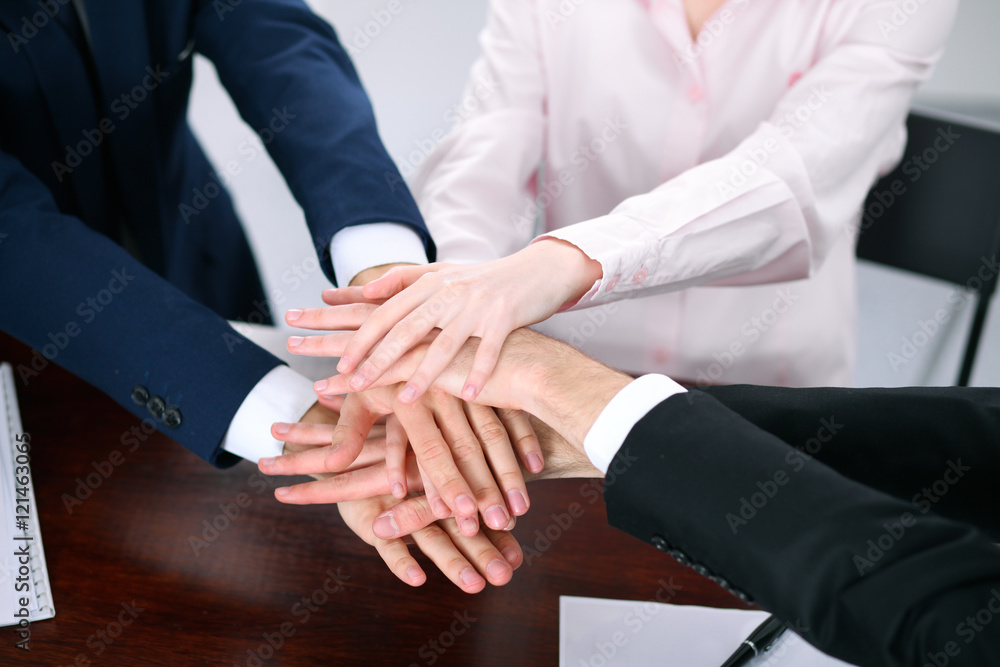 Business people group joining hands and representing concept of friendship and teamwork Business people group joining hands and representing concept of friendship and teamwork