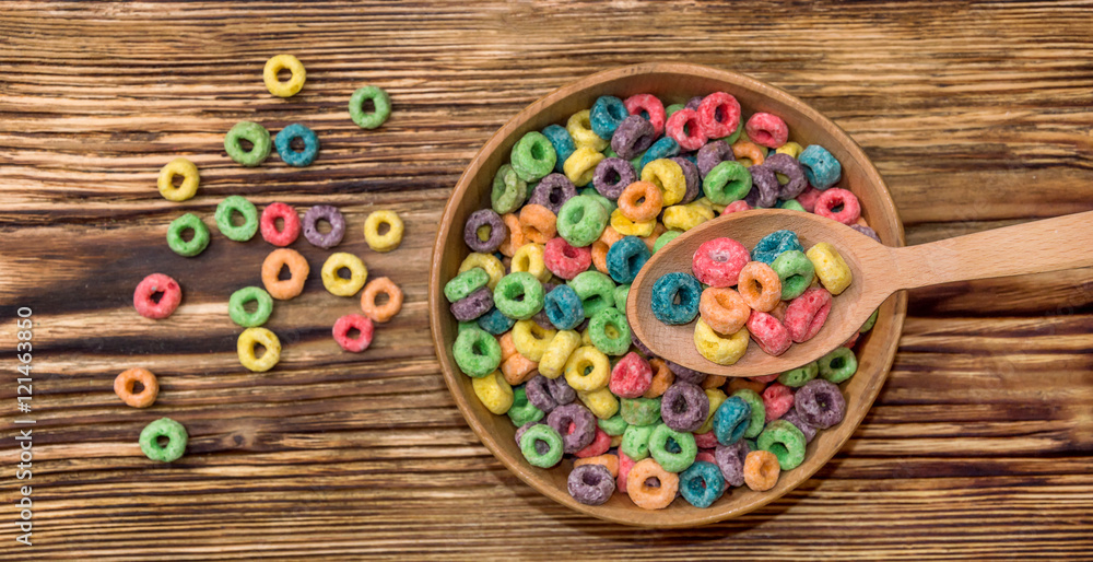 wooden spoon and wooden bowl with colorful cereal wooden spoon and wooden bowl with colorful cereal
