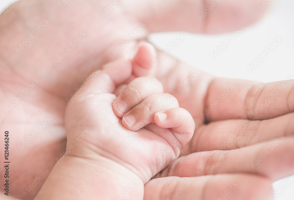 father holding baby hand,soft focus father holding baby hand,soft focus