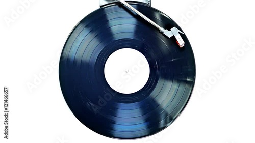 An old record spinning on a turntable isolated on white. UHD - 4K