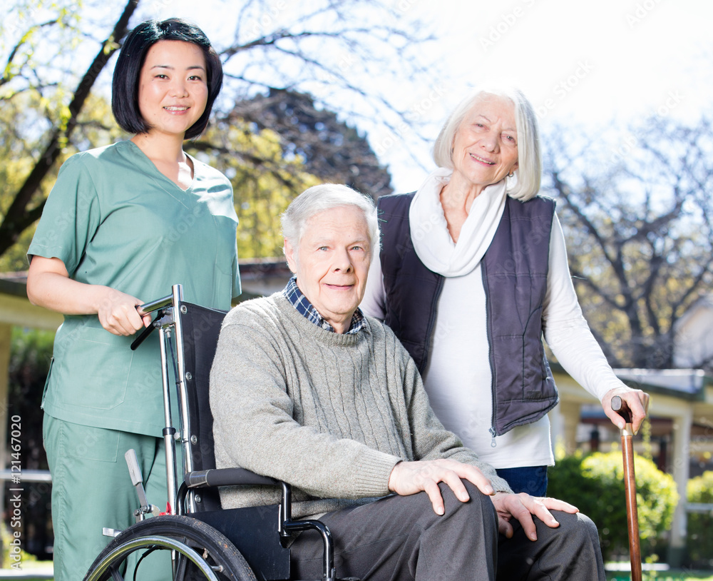 Elder people with wheelchair assisted by nurse outdoor Elder people with wheelchair assisted by nurse outdoor
