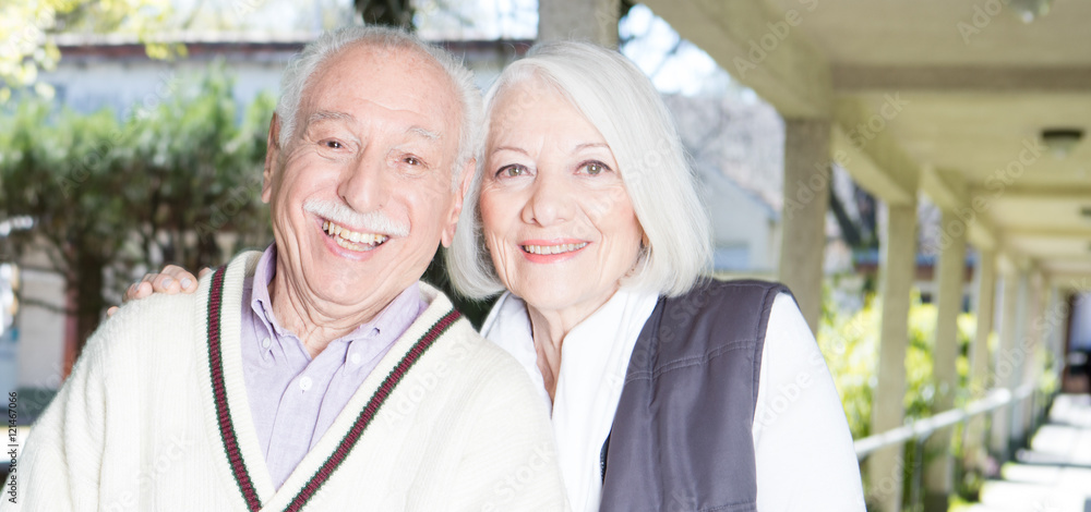 Happy elder couple in 70s relaxing together outdoor Happy elder couple in 70s relaxing together outdoor