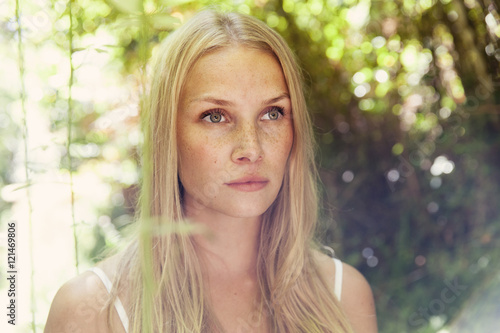 Portrait of young blond woman in the nature