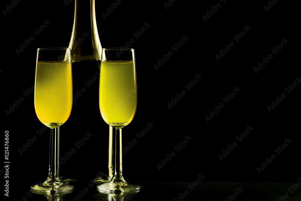 Glasses and bottle of champagne isolated on a black background