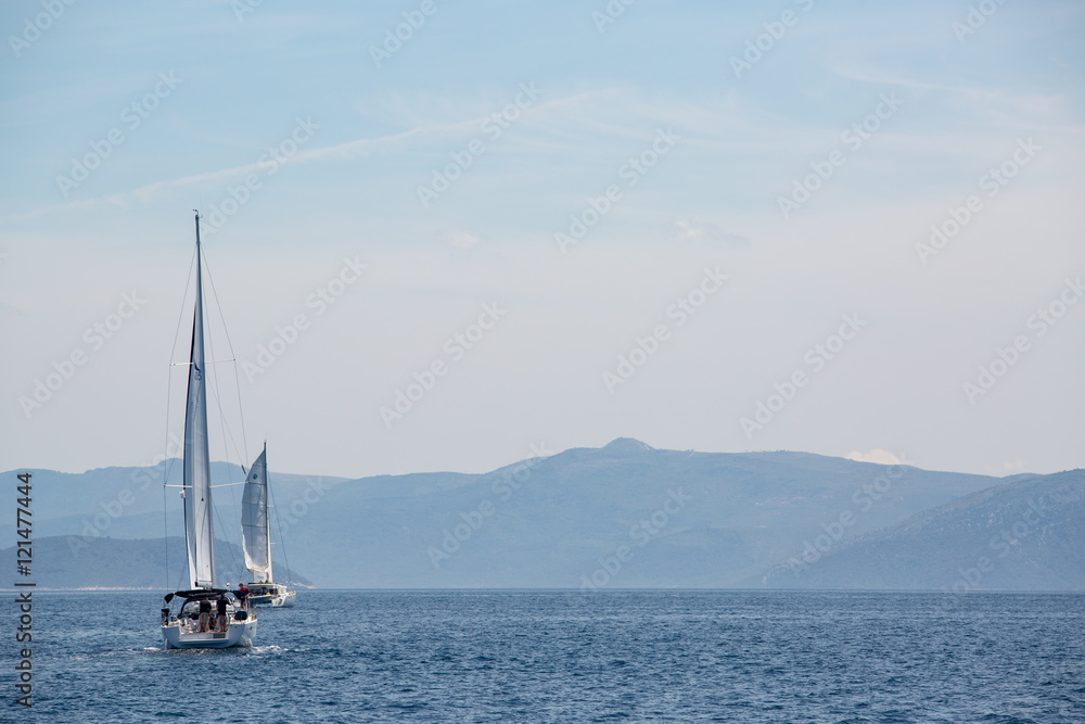 Obraz premium Sailing boat in the adriatic ocean, Croatia. Mountains on the horizon.
