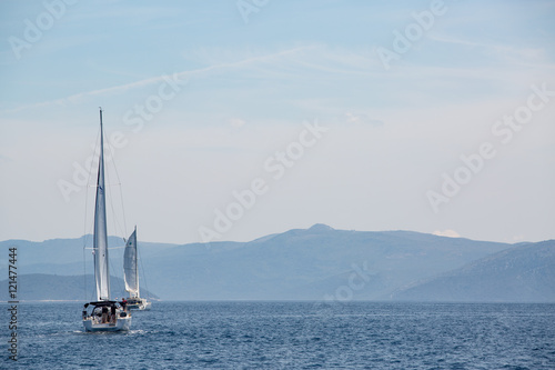 Sailing boat in the adriatic ocean, Croatia. Mountains on the horizon.