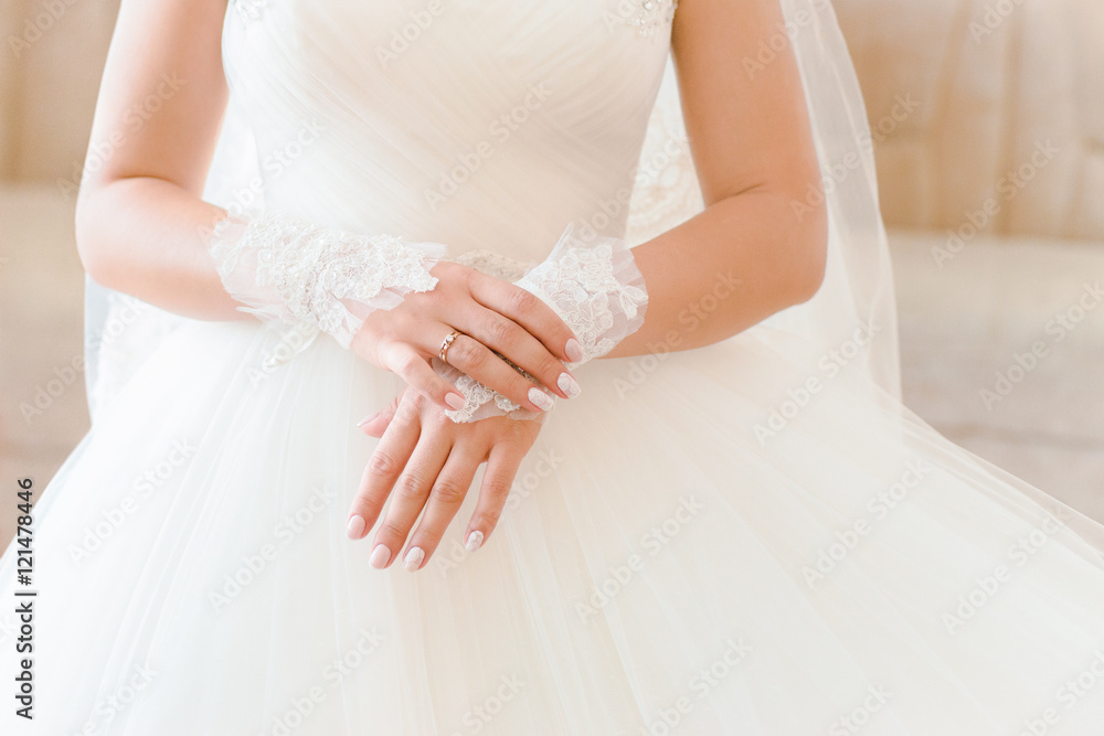 Bride's hands. Wedding dress, close up, indoor