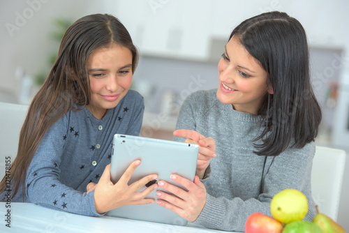 Mother and daughter looking at tablet