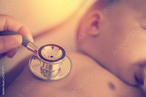 Wallpaper Mural Pediatric doctor exams newborn baby girl with stethoscope in hos Torontodigital.ca