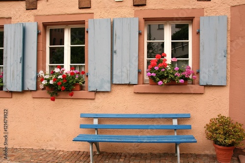 two windows with a bench 