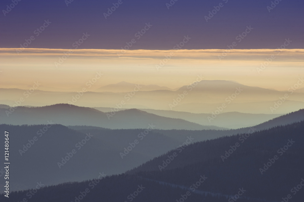 Lines of beautiful mountains in fog