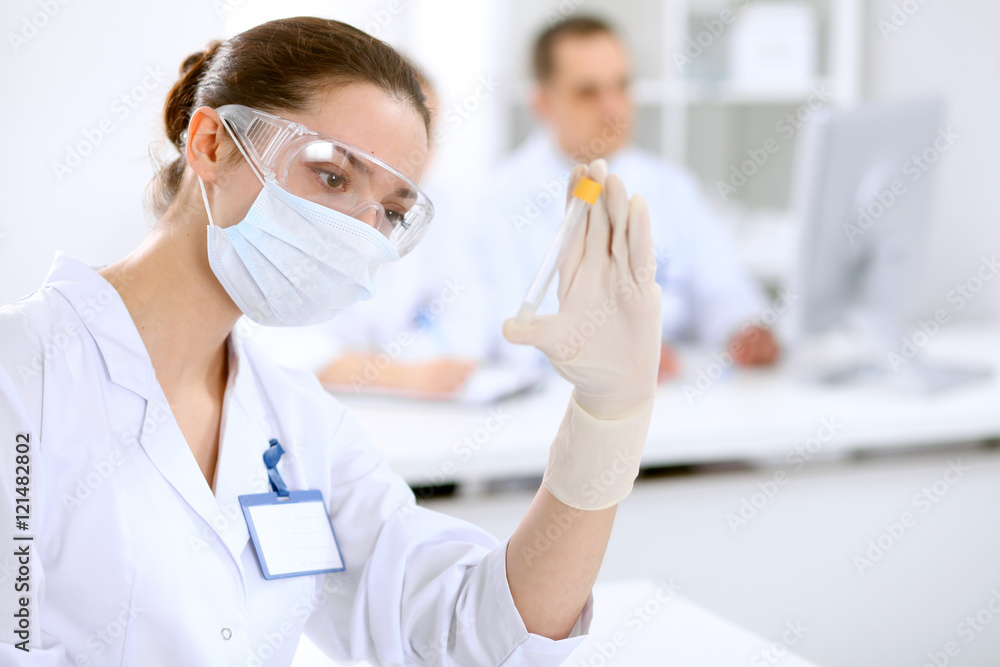 Scientific research team with clear solution in laboratory Scientific research team with clear solution in laboratory