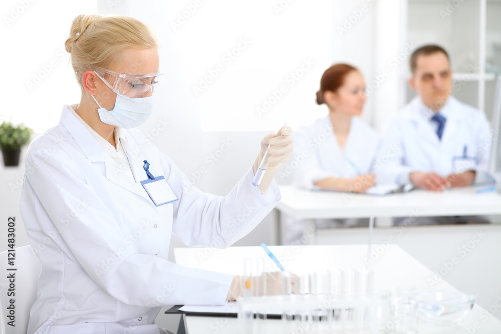 Scientific research team with clear solution in laboratory Scientific research team with clear solution in laboratory